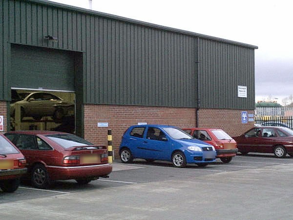 The Blossomgate Motors unit on Ripon Business Park, with cars parked outside the workshop door