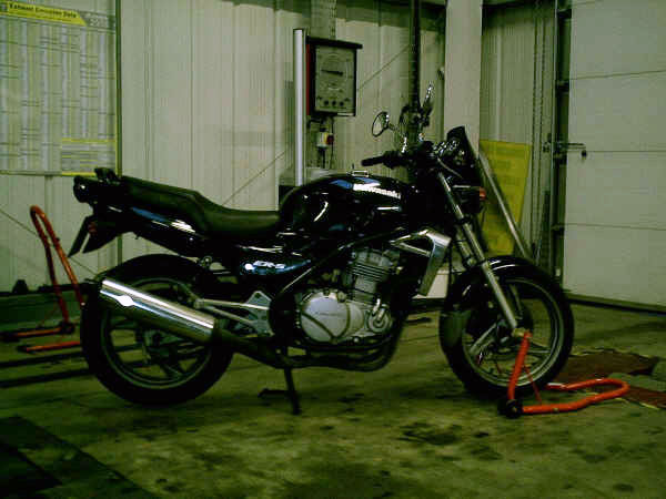 A motorbike on a paddock stand inside the Blossomgate Motors workshop
